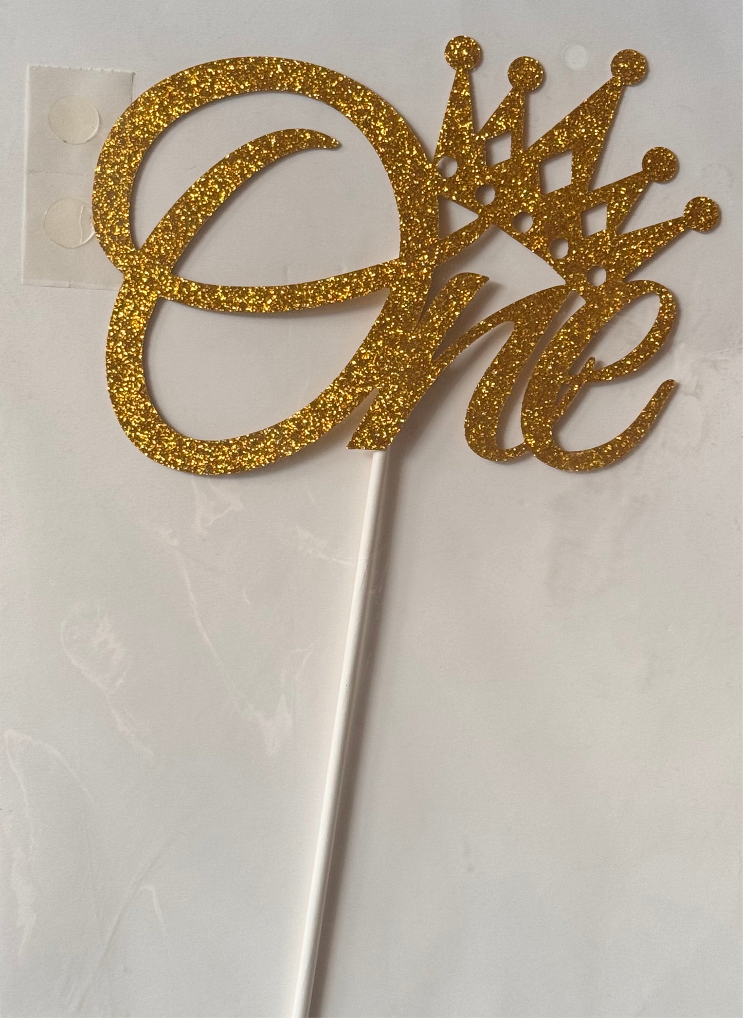 Word One gold paper cake topper