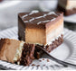 Slice of gluten-free vegan chocolate coconut cheesecake cake on a plate with a fork