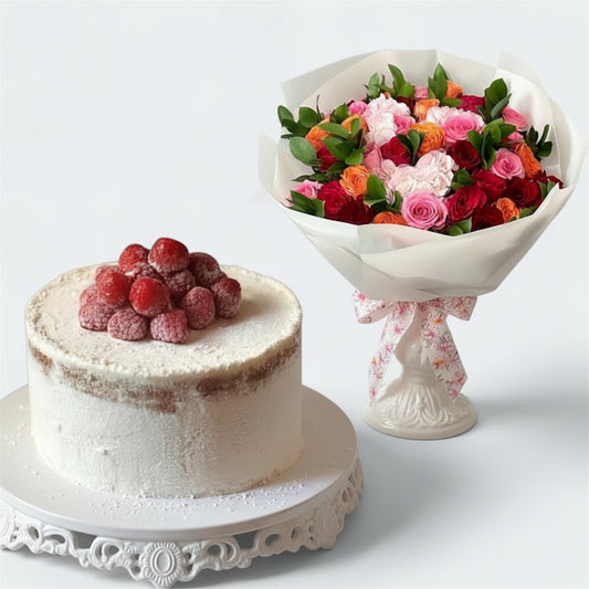 Bouquet of flowers next to a cake with berries on a white background